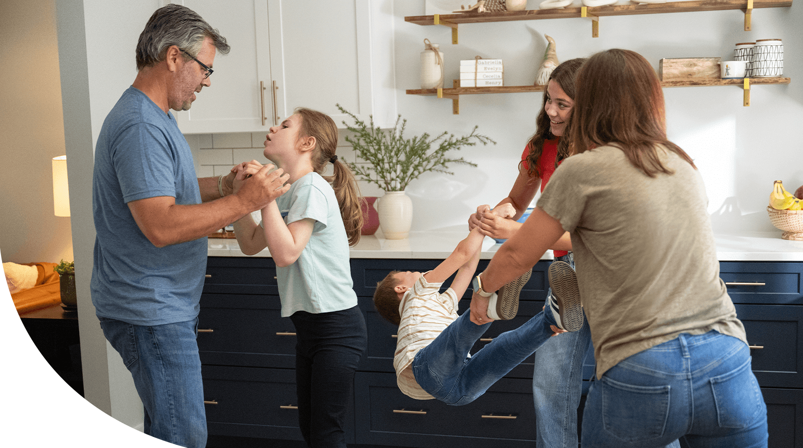 Evie playing with her family in their kitchen