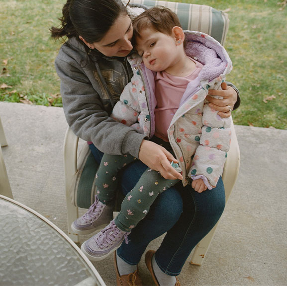 Diana holding Lina outside