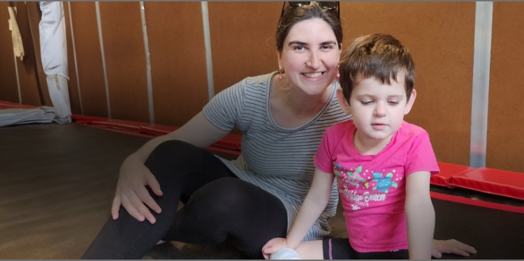 Diana and Lina sitting on the floor of a gym