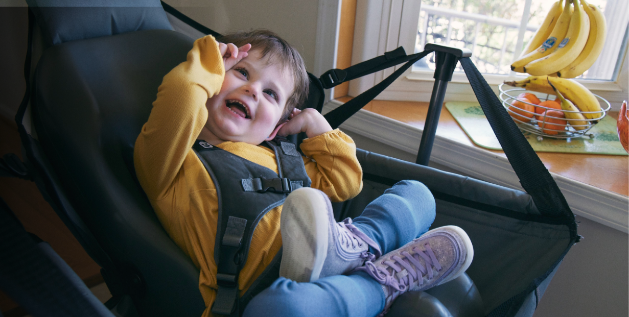 Lina sitting in a chair and laughing