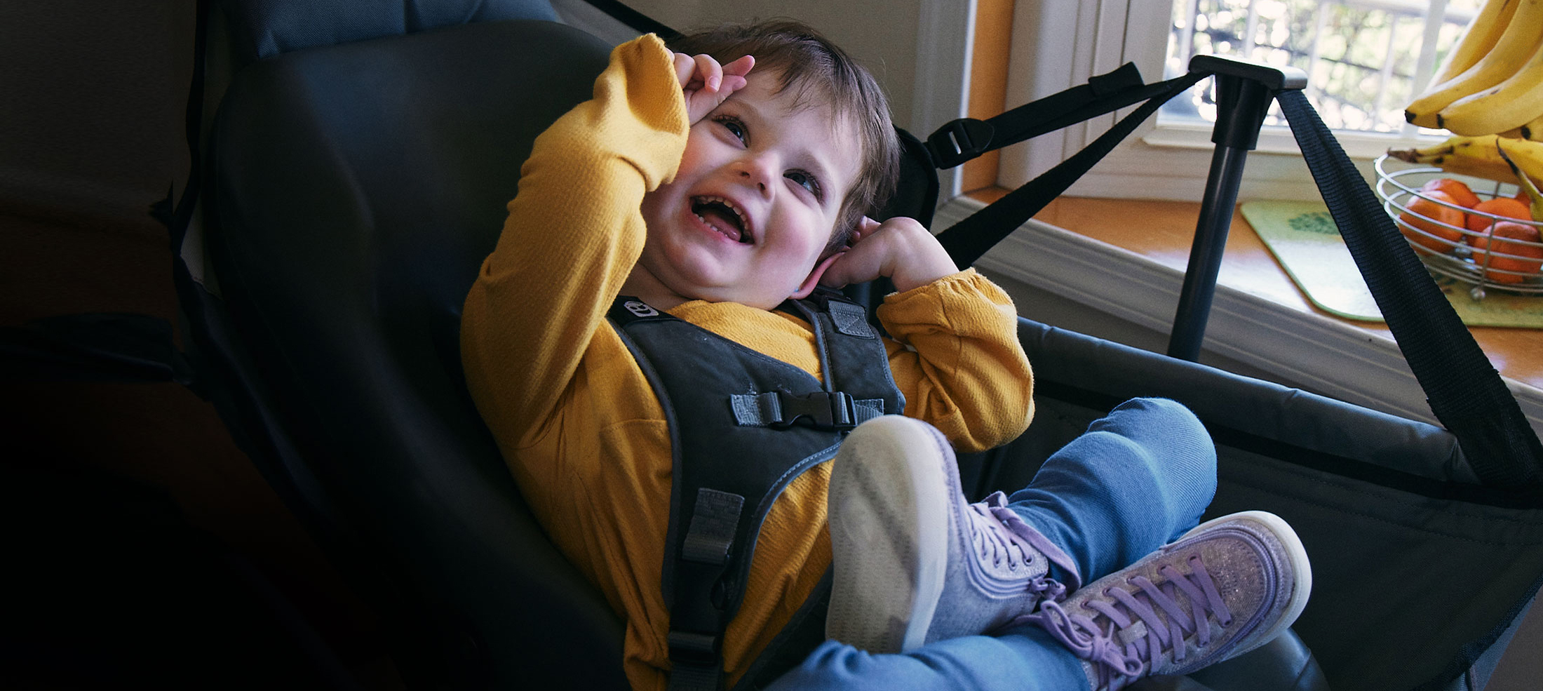 Lina sitting in a chair and laughing