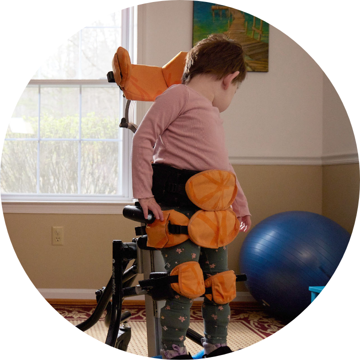 Lina using a standing chair in her room